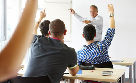 A college teacher in the classroom with his students